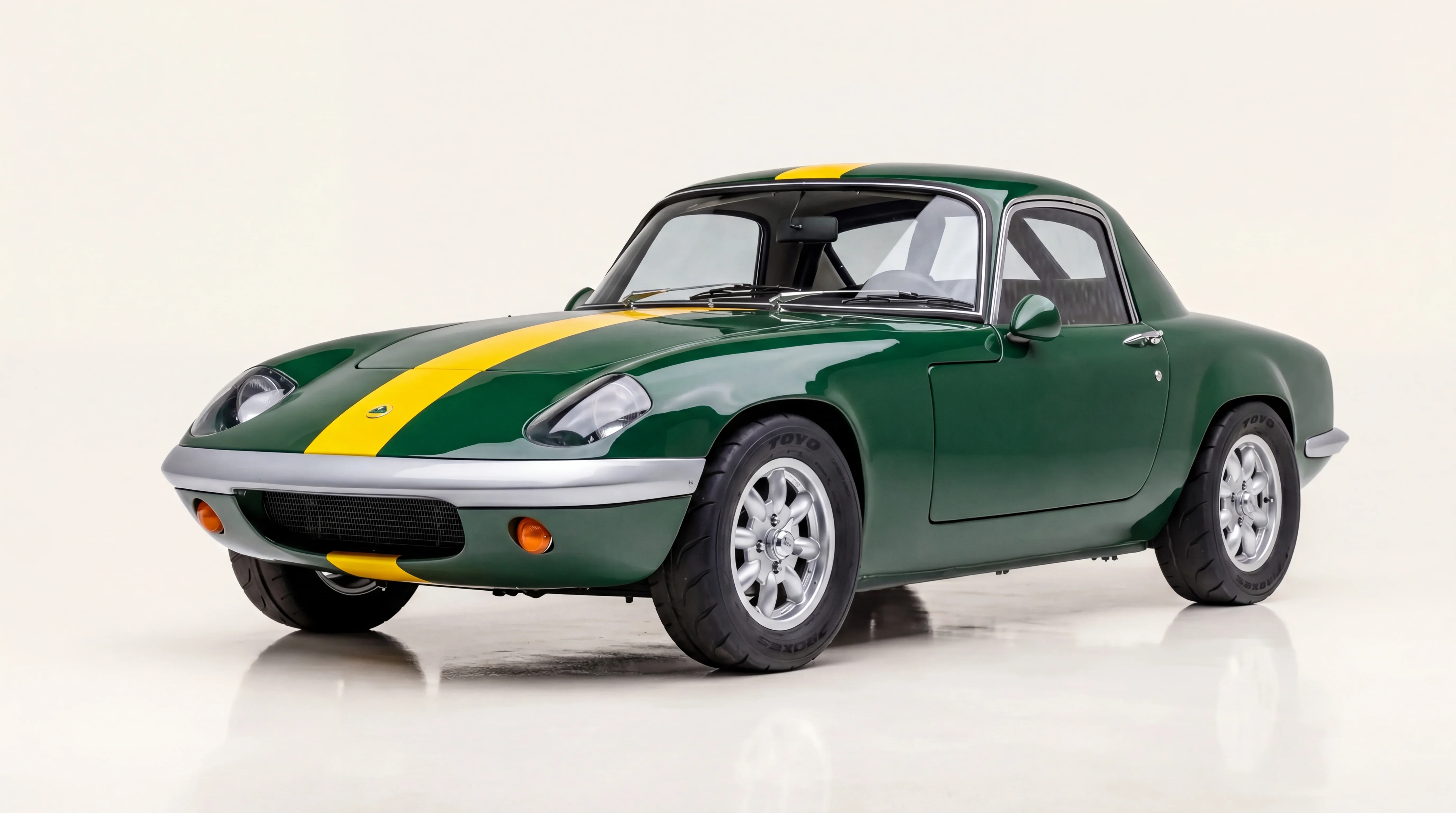 A 1965 Lotus Elan — British Racing Green with a yellow centerline stripe. Lightweight chassis, borrowed engine, built to win.